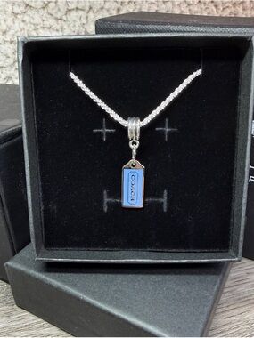 COACH Matte Hang Tag Light Blue on a small diamond cut Silver Chain (16”)
